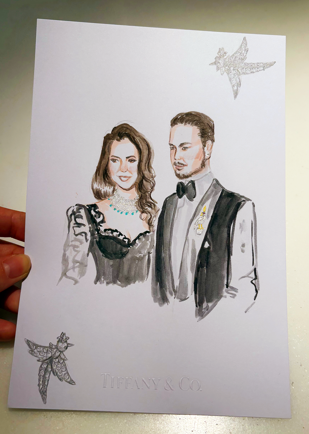 Illustration of man and woman wearing black outfits and Tiffany's jewelry